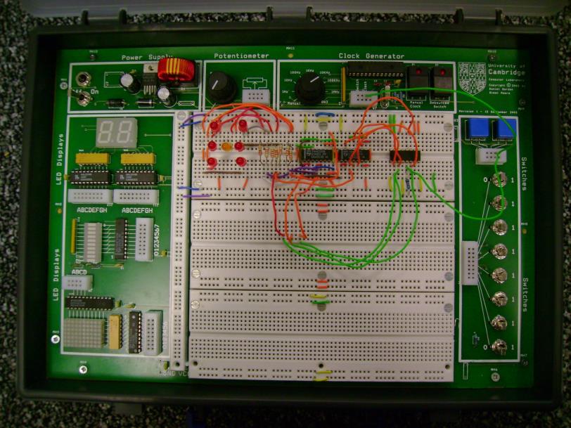 Prototyping box — PSU, clock generator, switches, breadboard, LEDs
